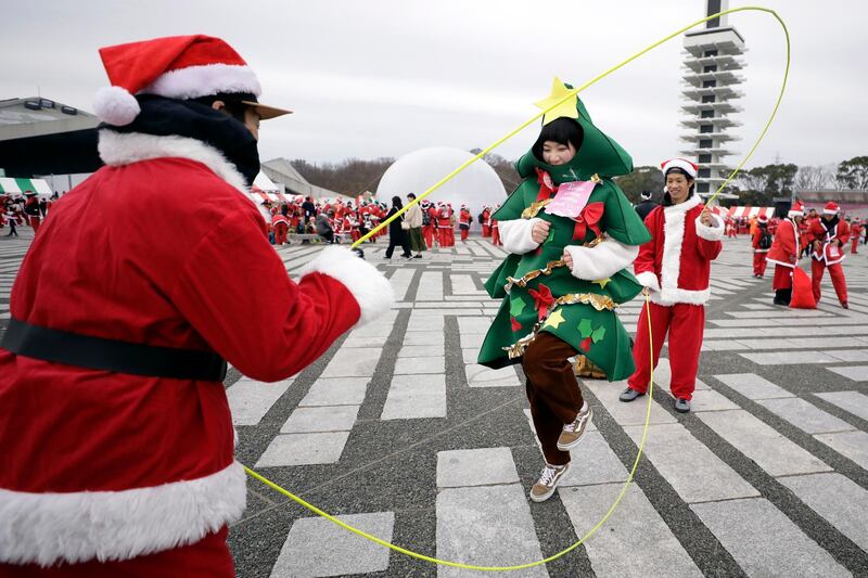 A participant dressed in a Christmas tree costume at the Tokyo Great Santa Run 2019 in Tokyo, Japan.  EPA