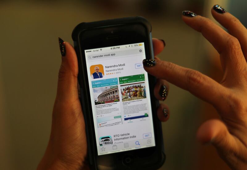 An Indian woman about to download Indian Prime Minister Narendra Modi's official smartphone app in New Delhi, India, Monday, March 26, 2018. Allegations that Indian Prime Minister Narendra Modi's official smartphone app is shipping Indians' personal data to servers abroad have degenerated into a sarcastic back-and-forth online. (AP Photo/Manish Swarup)