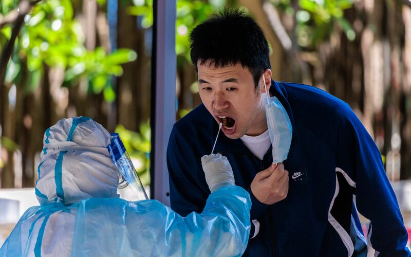 A man takes a Covid-19 test in Shanghai. EPA