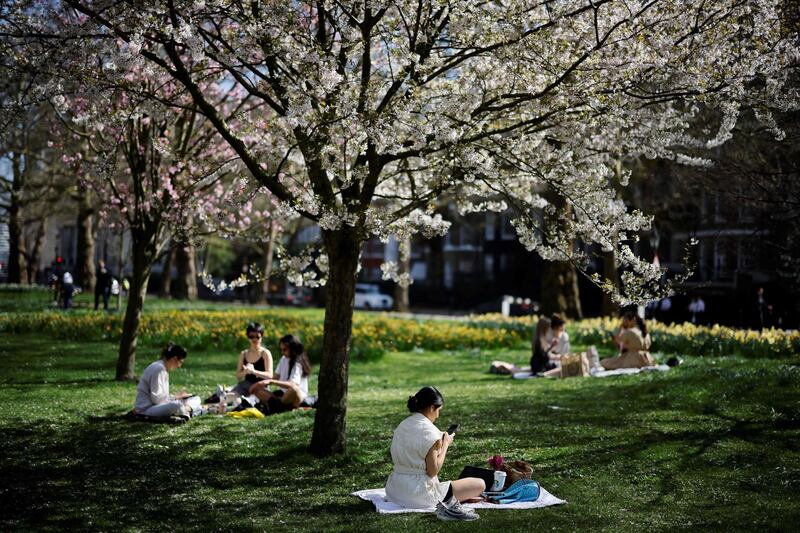 People enjoy the sunshine in St James Park, central London. AFP