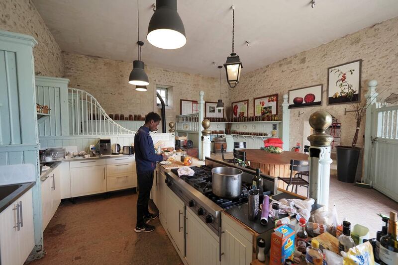 French half marathon runner Yosi Goasdoue cooks at the Chateau de la Bourdaisiere. AFP