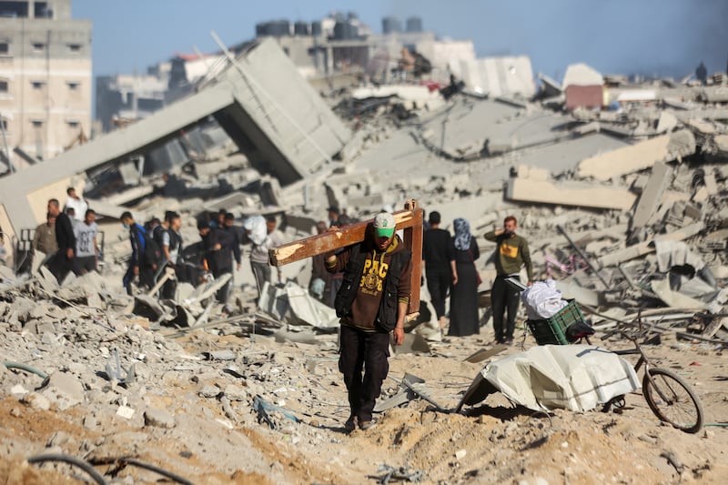 Palestinians inspect the damage caused by Israeli forces. Army radio said at least 200 'militants' were killed by Israeli forces, while Gaza health authorities say at least 300 people were killed. Reuters