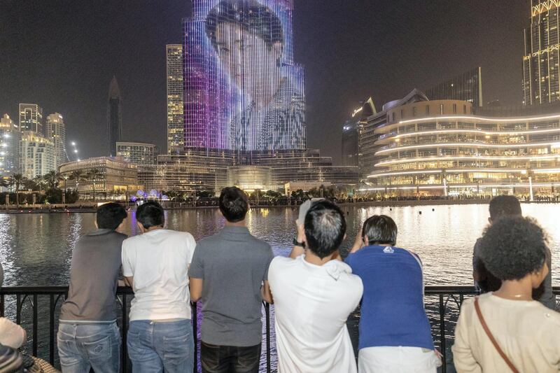 DUBAI, UNITED ARAB EMIRATES. 14 JULY 2018. Kpop Boyband EXO gets a LED light show on the Burj Khalifa. Fan’s gather to watch the show. (Photo: Antonie Robertson/The National) Journalist: Evelyn Lau. Section: National.