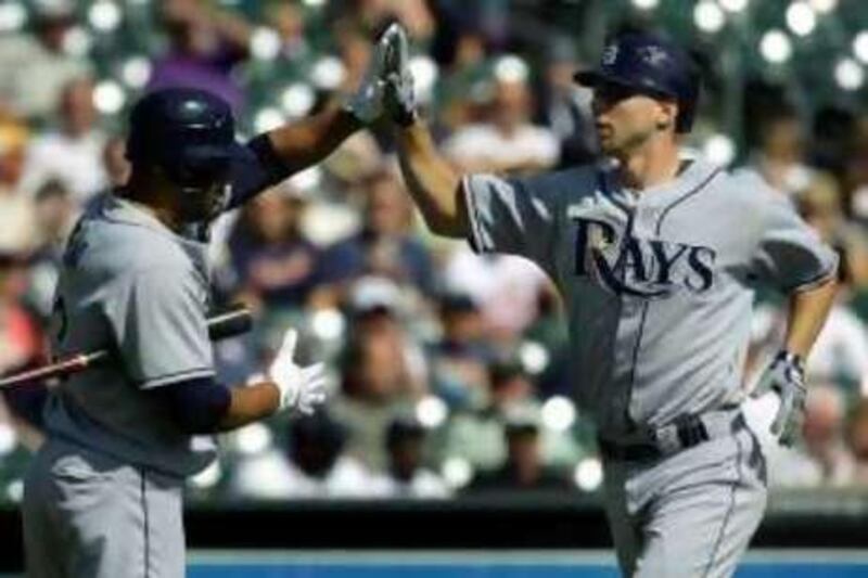 Tampa Bay Rays' Ben Zobrist, right, is congratulated by Carlos Pena after hitting a solo home run off Detroit Tigers pitcher Armando Galarraga in the first inning of a Major League Baseball game in Detroit, Thursday, Sept. 25, 2008.   (AP Photo/Paul Sancya)  *** Local Caption ***  MIPS103_Rays_Tigers_Baseball.jpg