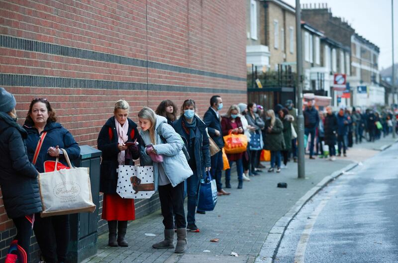 People queue outside the Waitrose and Partners supermarket, amid the coronavirus disease outbreak, in Balham, London, Britain. Reuters
