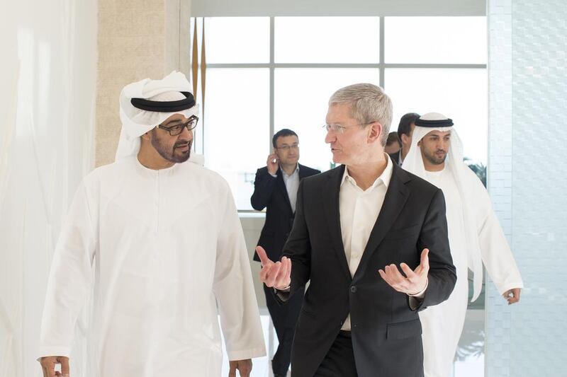 Sheikh Mohammed bin Zayed, left, receives Tim Cook, the CEO of Apple, right, prior to a meeting at Al Mamoura in Abu Dhabi. Ryan Carter / Crown Prince Court - Abu Dhabi