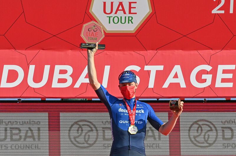 Sam Bennett celebrates on the podium after winning the sixth stage of the UAE tour cycling race, from Deira Islands to Palm Jumeriah, Dubai, United Arab Emirates, Friday, Feb. 26, 2021. (Gian Mattia D'Alberto/LaPresse via AP)