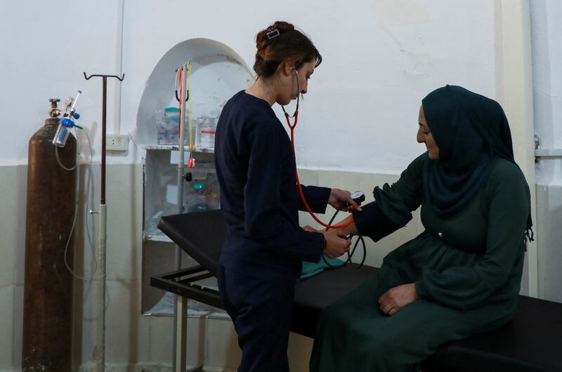 A nurse at the village clinic examines a patient in Jinwar