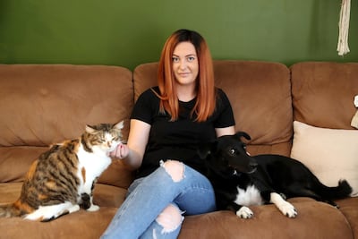 DUBAI, UNITED ARAB EMIRATES , September 15 – 2020 :- Samantha Vince with her dog and cat at her home in the Zahra apartments at Town Square in Dubai.  (Pawan Singh / The National) For News/Online. Story by Kelly