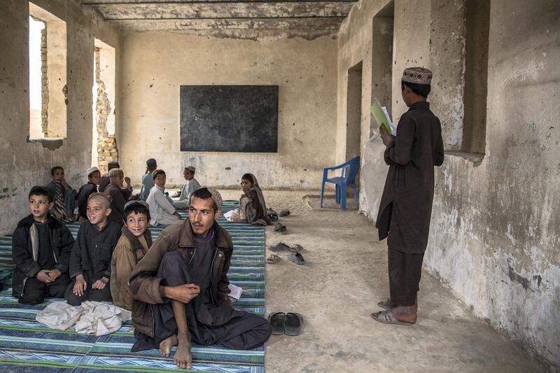 Children sit in a classroom at Shahid Niamatullah Primary School in Panjwayi district, formerly occupied by ISAF and the Afghan National Police. 