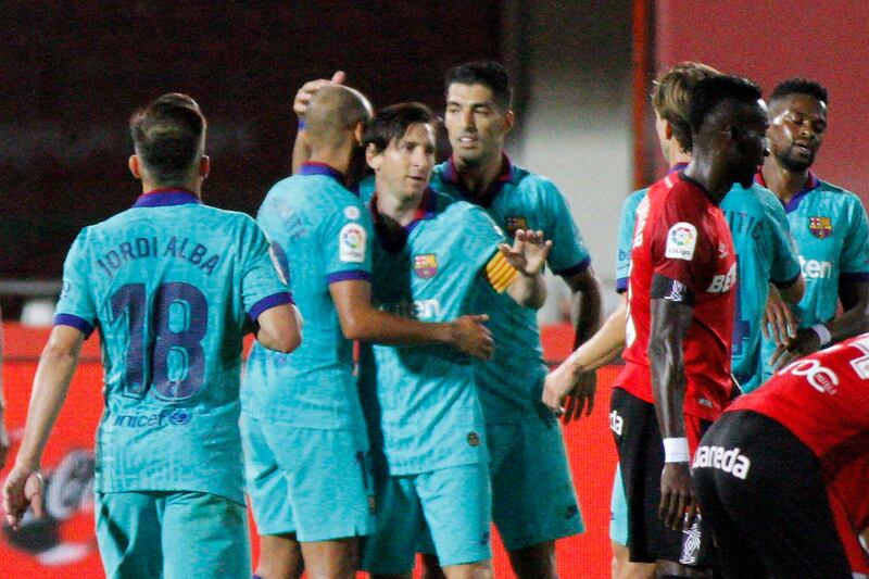 Barcelona's Lionel Messi, centre, celebrates with his teammates after scoring his side's fourth goal against Real Mallorca at Son Moix Stadium. AP Photo