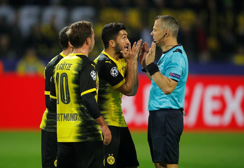 Borussia Dortmund players Nuri Sahin and Mario Gotze appeal to referee Bjorn Kuipers. Leon Kuegeler / Reuters