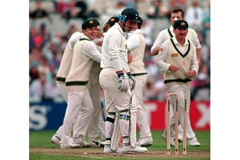 England batsman Mike Gatting looks down at the stumps after being bowled out by the Australian spinner Shane Warne.