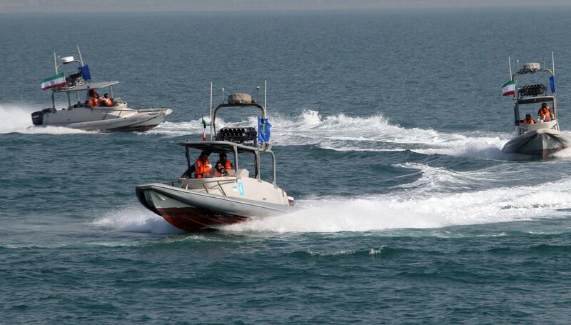 (FILES) In this file photo taken on July 2, 2012, members of Iran's Islamic Revolutionary Guard Corps (IRGC) ride in speed boats during a ceremony to commemorate the 24th anniversary of the downing of Iran Air flight 655 by the US navy, at the port of Bandar Abbas. Iran on September 16 seized a boat suspected of being used to smuggle fuel, and arrested its 11 crew members near the vital Strait of Hormuz oil shipping lane, state television reported. A naval patrol of the IRGC intercepted the vessel carrying 250,000 litres of fuel, state TV's website said, citing a commander of the force. / AFP / ATTA KENARE
