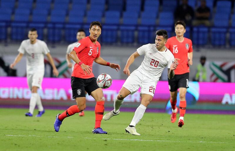 DUBAI , UNITED ARAB EMIRATES , January  7 – 2019 :- Jung Wooyoung ( no 5 in red ) of Korea Republic and Javier Patino ( no 20 in white ) of Philippines in action during the AFC Asian Cup UAE 2019 football match between KOREA REPUBLIC vs. PHILIPPINES held at Al-Maktoum Stadium in Dubai. Korea Republic won the match by 1-0. ( Pawan Singh / The National ) For News/Sports