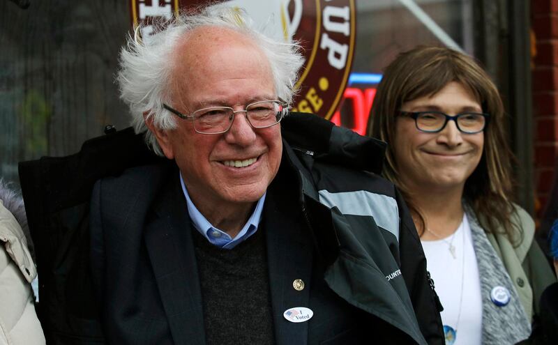 U.S. Sen. Bernie Sanders, I-Vt., left, smiles as he poses for a photograph with Vermont Democratic gubernatorial candidate Christine Hallquist, right, outside City Hall in Saint Albans, Vt., Tuesday, Nov. 6, 2018. (AP Photo/Charles Krupa)