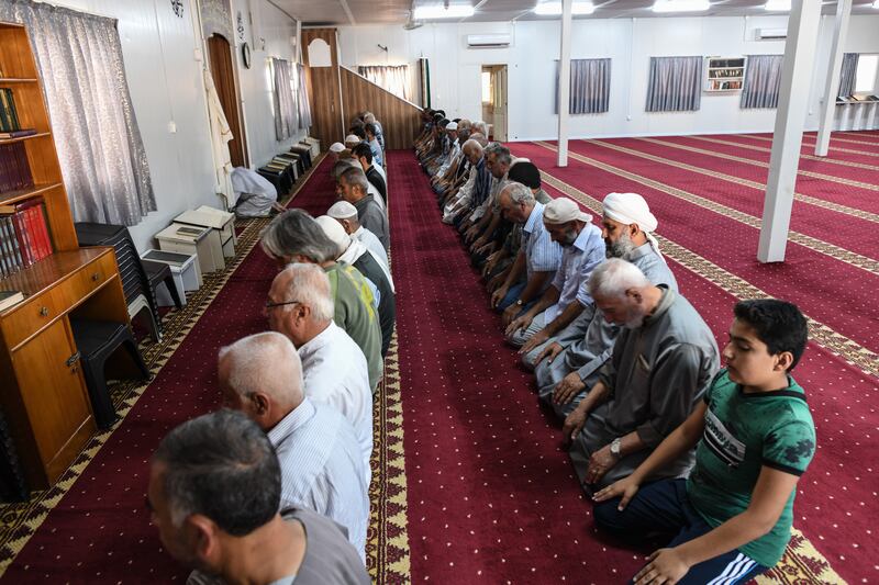 Syrian refugees pray in a mosque at the camp. Getty Images