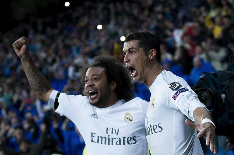 Cristiano Ronaldo (R) of Real Madrid CF celebrates scoring their third goal with teammate Marcelo (L) during the UEFA Champions League quarter final second leg match between Real Madrid CF and VfL Wolfsburg at Estadio Santiago Bernabeu on April 12, 2016 in Madrid, Spain. Gonzalo Arroyo Moreno/Getty Images