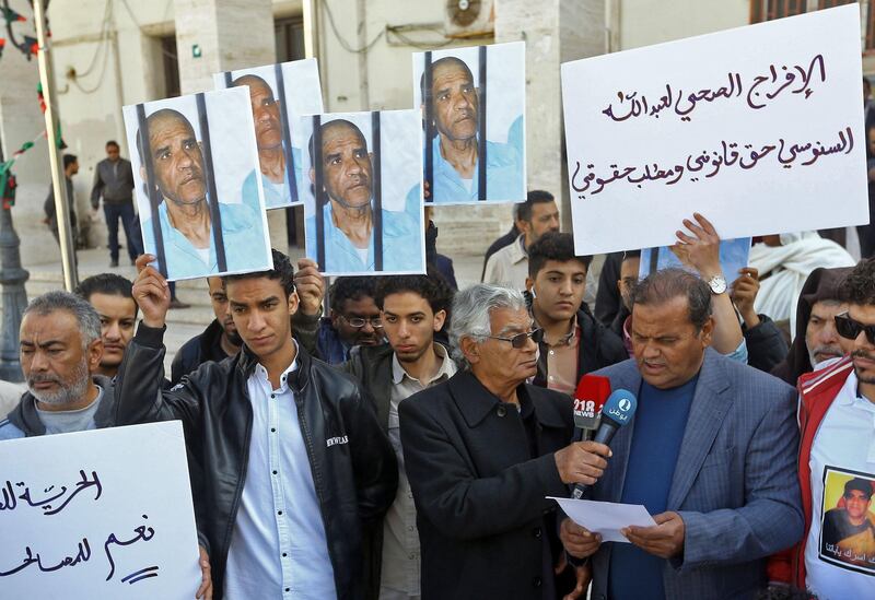 Family and tribe members of imprisoned former Libyan intelligence chief Abdullah al-Sanussi, demonstrate with signs calling for his release and showing his picture on posters, in the Libyan capital Tripoli.  AFP