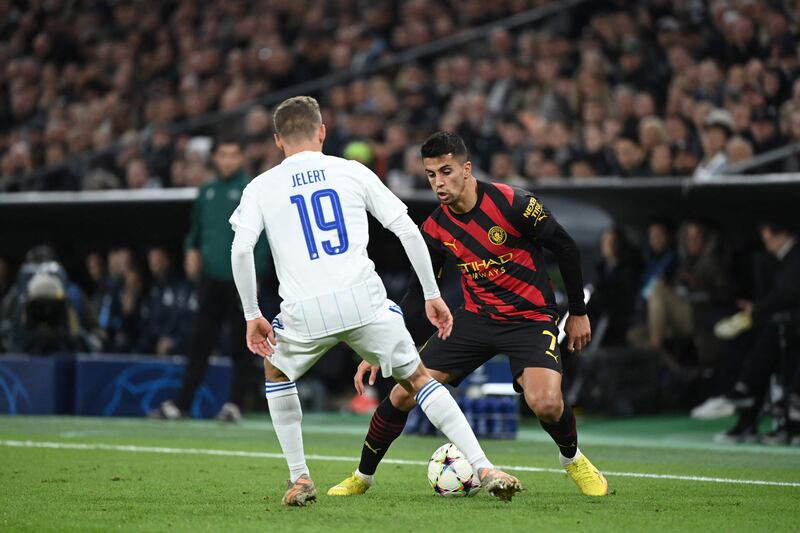 Manchester City's Joao Cancelo takes on FC Copenhagen's Elias Jelert in a Champions League clash. AFP
