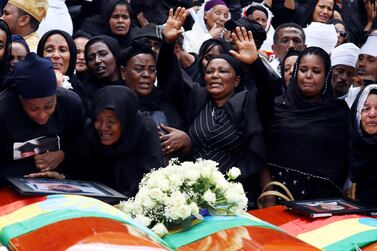 Mourners cry next to their relatives' coffins during the burial ceremony of the Ethiopian Airline Flight ET 302 crash victims at the Holy Trinity Cathedral Orthodox church in Addis Ababa, Ethiopia. Reuters 