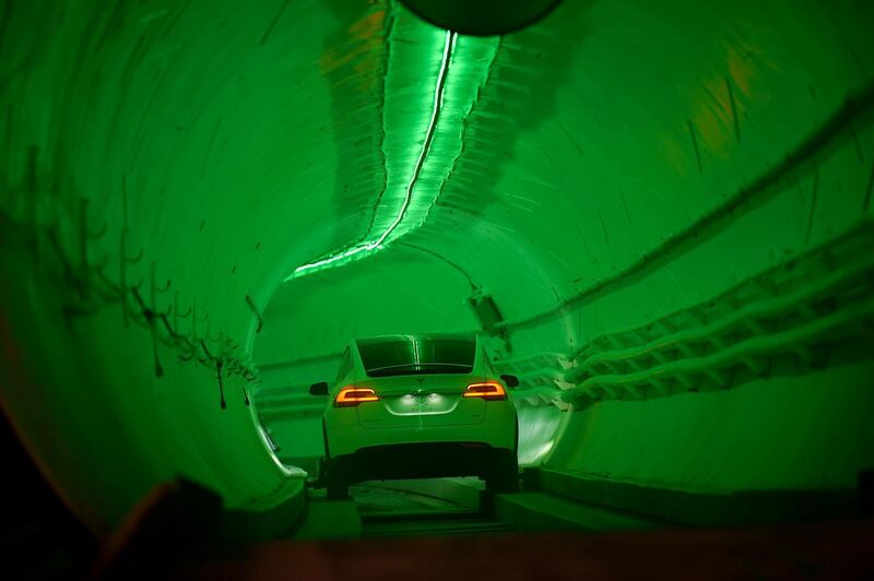 A modified Tesla Model X drives in the tunnel entrance. EPA