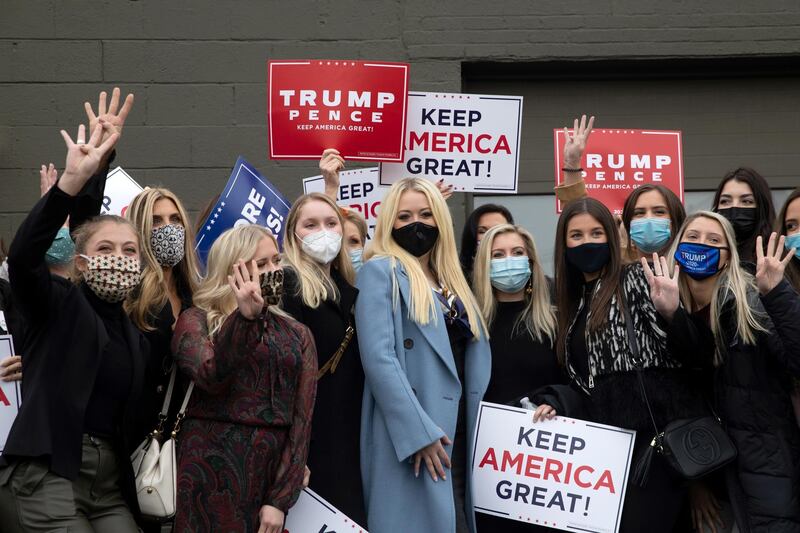 Women voters gather outside with signs for a group photo with Tiffany Trump in Birmingham, Michigan. Reuters