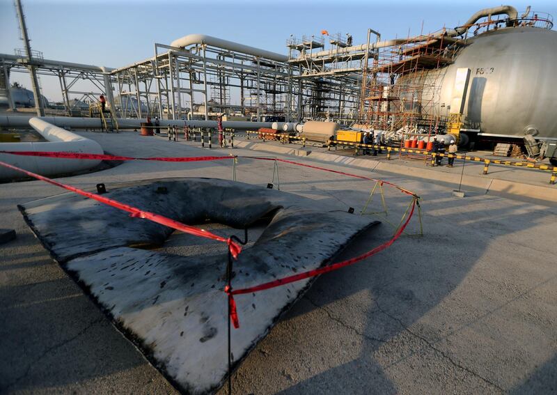 FILE PHOTO: A metal part of a damaged tank is seen at the damaged site of Saudi Aramco oil facility in Abqaiq, Saudi Arabia, September 20, 2019. REUTERS/Hamad l Mohammed/File Photo