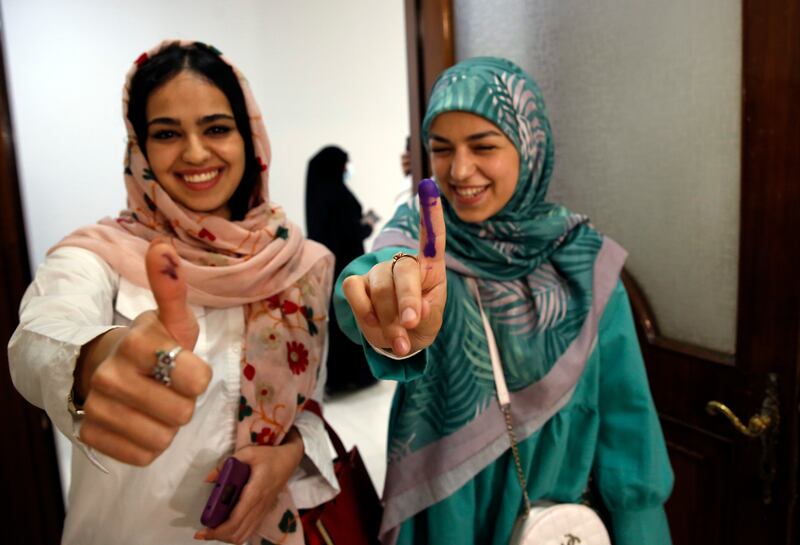 Lebanese girls residing in Iran show their inked fingers after casting their votes during the parliamentary elections at a polling station at the Lebanon embassy in Tehran, Iran. EPA