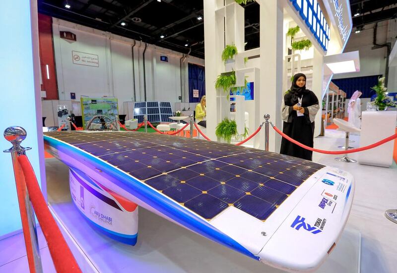 Above, Adnoc displays its solar car at the Gulfsol event in Dubai. Victor Besa for The National
