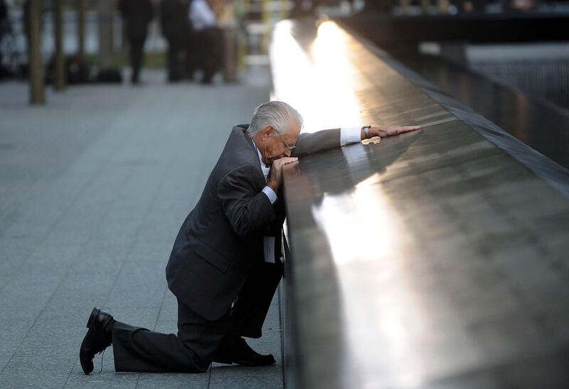 Robert Peraza, who lost his son Robert David Peraza, pauses at his son's name at the North Pool of the 9/11 Memorial during tenth anniversary ceremonies at the site of the World Trade Center in New York, September 11, 2011. The 9/11 attacks changed life in the United States forever, but 10 years after the devastating hit, New Yorkers have learned to live in a more dangerous world and are ready to move on.      REUTERSJustin Lane/Pool   (UNITED STATES - Tags: ANNIVERSARY DISASTER TPX IMAGES OF THE DAY) *** Local Caption ***  NYC402_SEPT11_0911_11.JPG