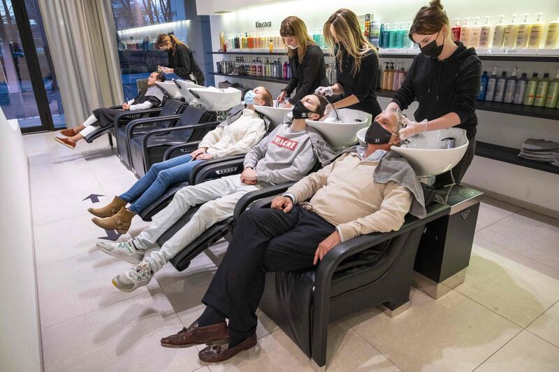 Hairdressers and clients wear masks in Amsterdam, Netherlands. AFP