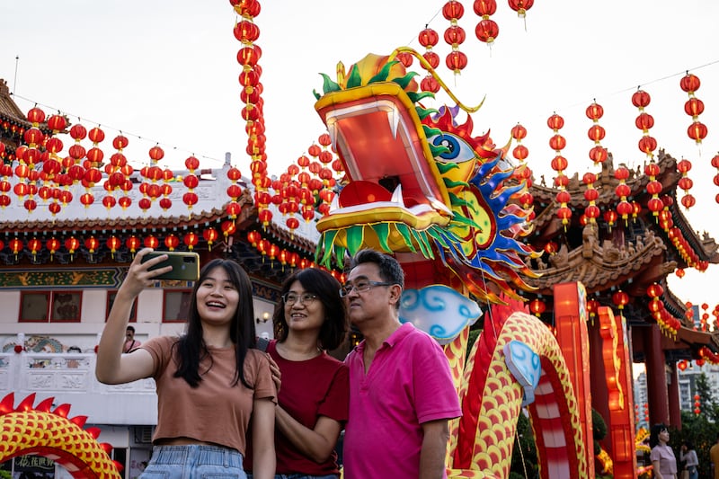 Selfies with a decorative dragon lantern during Lunar New Year celebrations at Thean Hou Temple in Kuala Lumpur, Malaysia. Getty Images