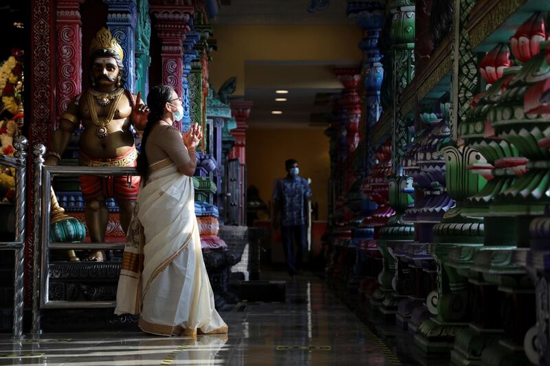 A devotee wearing a protective mask prays at a temple, during the Hindu festival of Diwali, amid the coronavirus disease (COVID-19) outbreak in Kuala Lumpur, Malaysia November 14, 2020. REUTERS/Lim Huey Teng TPX IMAGES OF THE DAY
