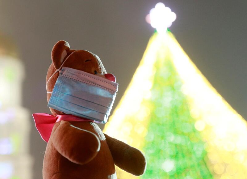 A toy bear with a protective mask is seen at a Christmas fair in central Kyiv, Ukraine. Reuters