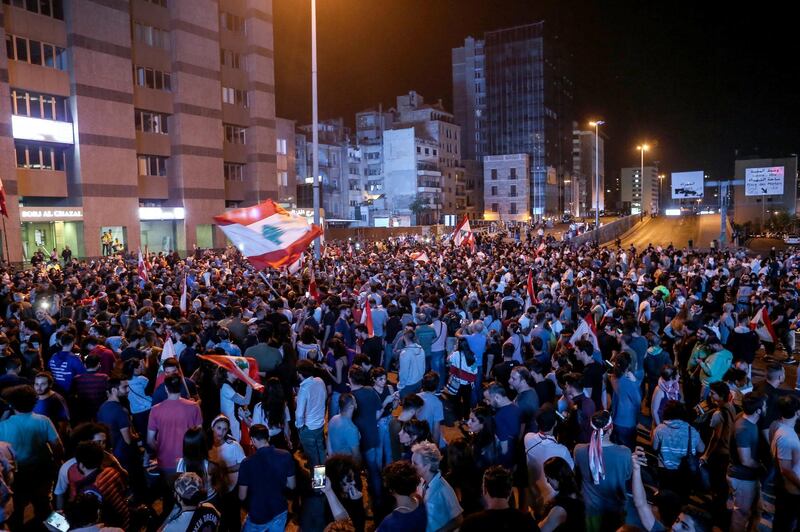 Protesters wave lebanese flags shout slogans as they block the Ring Bridge highway during a protest in Beirut.  EPA