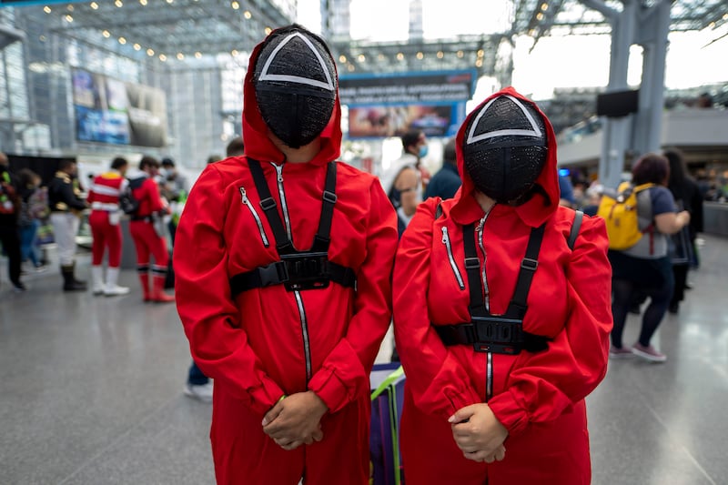 Attendees dressed as characters from 'Squid Game' pose during New York Comic Con. Charles Sykes / Invision / AP