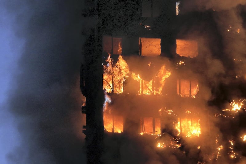 Flames and smoke engulf Grenfell Tower, a residential block on June 14, 2017 in west London. - The massive fire ripped through the 27-storey apartment block in west London in the early hours of Wednesday, trapping residents inside as 200 firefighters battled the blaze. Police and fire services attempted to evacuate the concrete block and said "a number of people are being treated for a range of injuries", including at least two for smoke inhalation. (Photo by Daniel LEAL-OLIVAS / AFP)