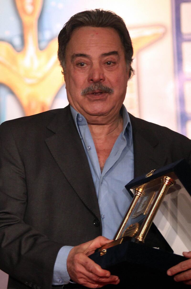 Egyptian actor Yussef Shaaban poses with his lifetime achievement award during the 31st Egyptian Cinema Oscars in Cairo, late February 12, 2010. AFP PHOTO/AMR AHMAD (Photo by AMR AHMAD / AFP)