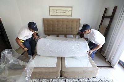 Dubai, United Arab Emirates - September 12, 2018: Zeeshan Malik (R) and Mani Butt deliver the mattress. Feature story about "mattress in a box". Wednesday, September 12th, 2018 at Mira, Dubai. Chris Whiteoak / The National