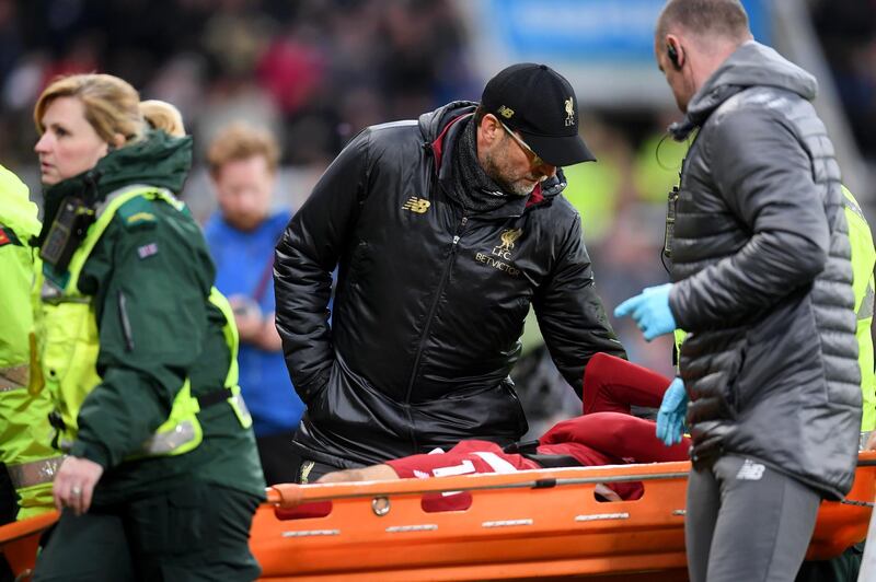 Manager Jurgen Klopp speaks with Salah as he is carried off the pitch on a stretcher. Laurence Griffiths / Getty Images