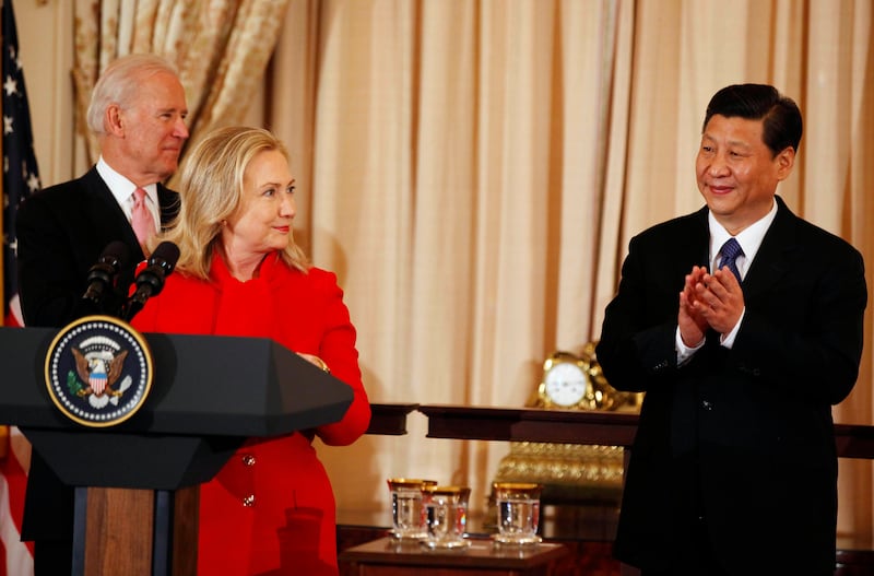 Mr Xi applauds next to US secretary of state Hillary Clinton and Mr Biden (L) at a luncheon at the State Department in Washington in February 2012. Reuters