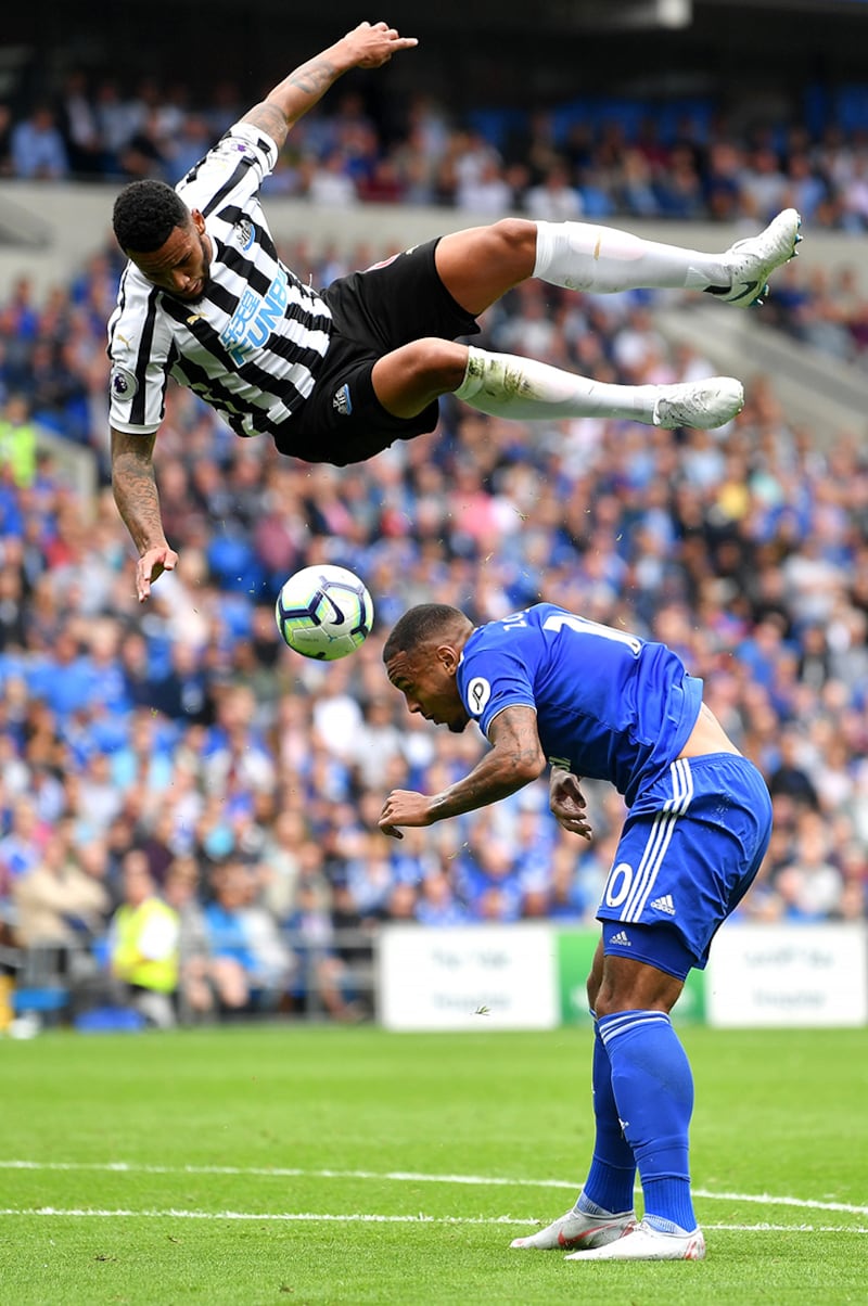Jamaal Lascelles of Newcastle United takes the aerial route as he challenges Kenneth Zohore of Cardiff City for the ball. 18/08/2018. Dan Mullan / FPA / LDY Agency