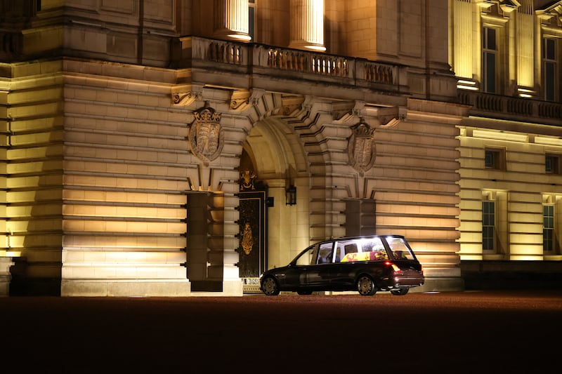 The hearse continues on its sombre journey into the palace. PA
