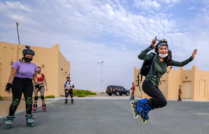 Abu Dhabi, United Arab Emirates, August 21, 2020.   The Madrollers skating group at the Al Wathba Bicycle Track do a  8 km. fun sprint.
  The skating group has members from Dubai and Abu Dhabi.  They encourage safety and discipline on roller-skates, skateboard, long-board and bicycles.  --Rollerbladers do limbering exercises before going on the 8 km fun sprint.
Victor Besa /The National
Section:  Photo Project
Reporter: