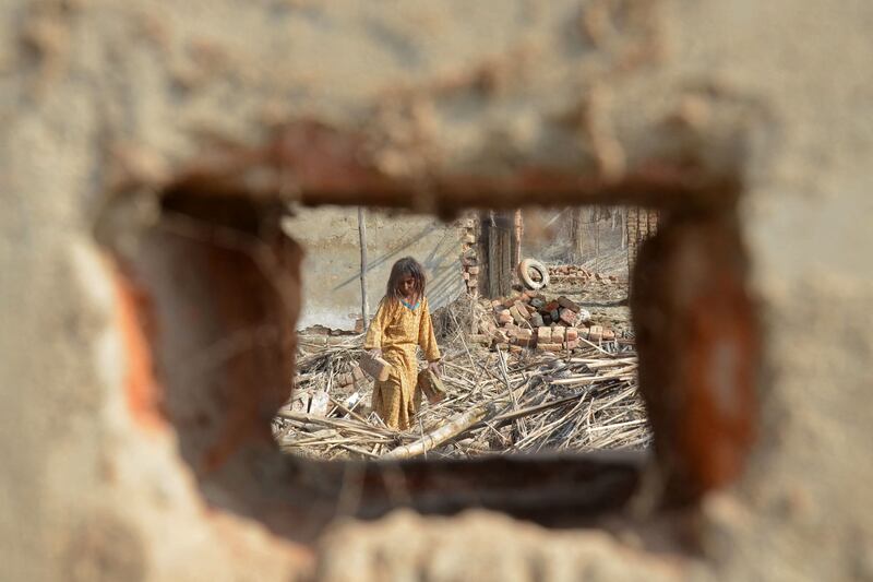 A girl collects bricks from the debris of her damaged house in a flood-hit area of Balochistan province, Pakistan. The UN has called for ‘massive investment’ to help the stricken region. AFP