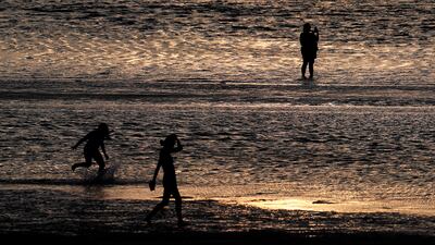 People at Skaket Beach, Cape Cod, Massachusetts. US companies are now offering employees more paid time off for a better work-life balance. EPA 