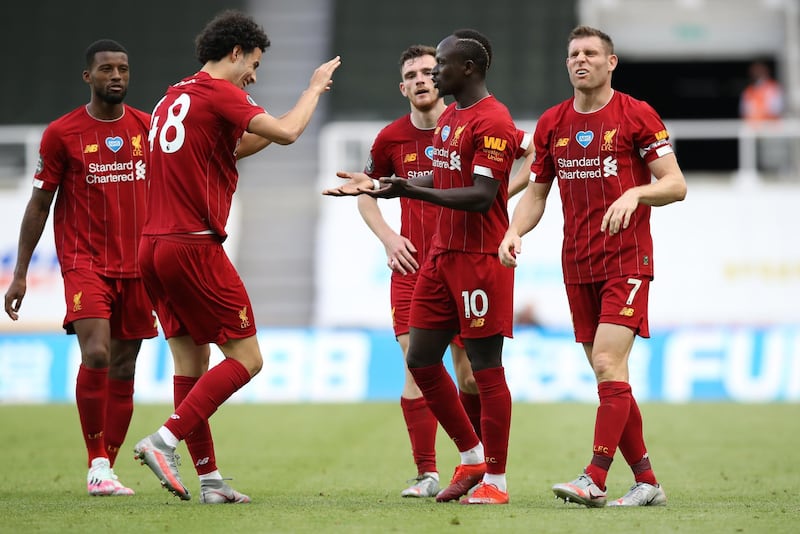 Soccer Football - Premier League - Newcastle United v Liverpool - St James' Park, Newcastle, Britain - July 26, 2020  Liverpool's Sadio Mane celebrates scoring their third goal with teammates, as play resumes behind closed doors following the outbreak of the coronavirus disease (COVID-19) Pool via REUTERS/Owen Humphreys EDITORIAL USE ONLY. No use with unauthorized audio, video, data, fixture lists, club/league logos or 'live' services. Online in-match use limited to 75 images, no video emulation. No use in betting, games or single club/league/player publications.  Please contact your account representative for further details.