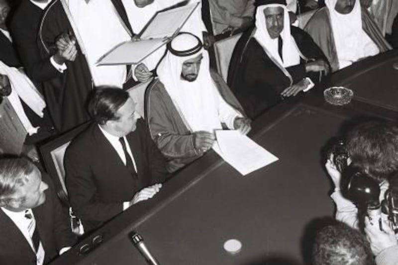 History Project 2010, "The First Day". The signing and speech at Union House, Dubai. December 2, 1971. Sheikh Zayed reads the treaty of friendship watched by (from left) James Treadwell and Sir Geoffrey Arthur of Britain. On his other side are Shiekh Rashid of Dubai and Sheikh Khalid of Sharjah. Behind him are Ahmed al Suwaidi, Mahdi al Tajir and Shiekh Maktoum bin Rashid.  Credit Ittihad Newspaper **EDS NOTE ***IMPORTANT** SEEK ADVISE FROM KAREN BEFORE USE
