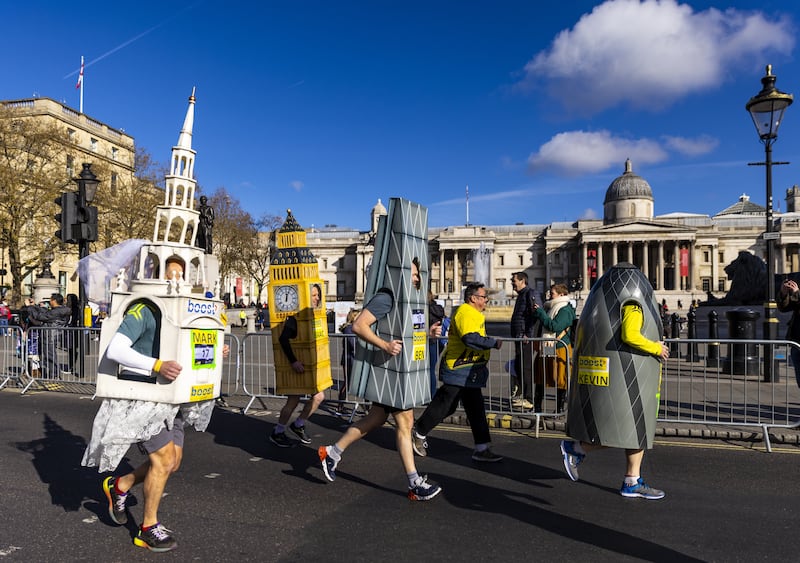 Runners dressed up as famous London buildings head past the National Gallery during the 2022 London Landmarks Half Marathon. PA